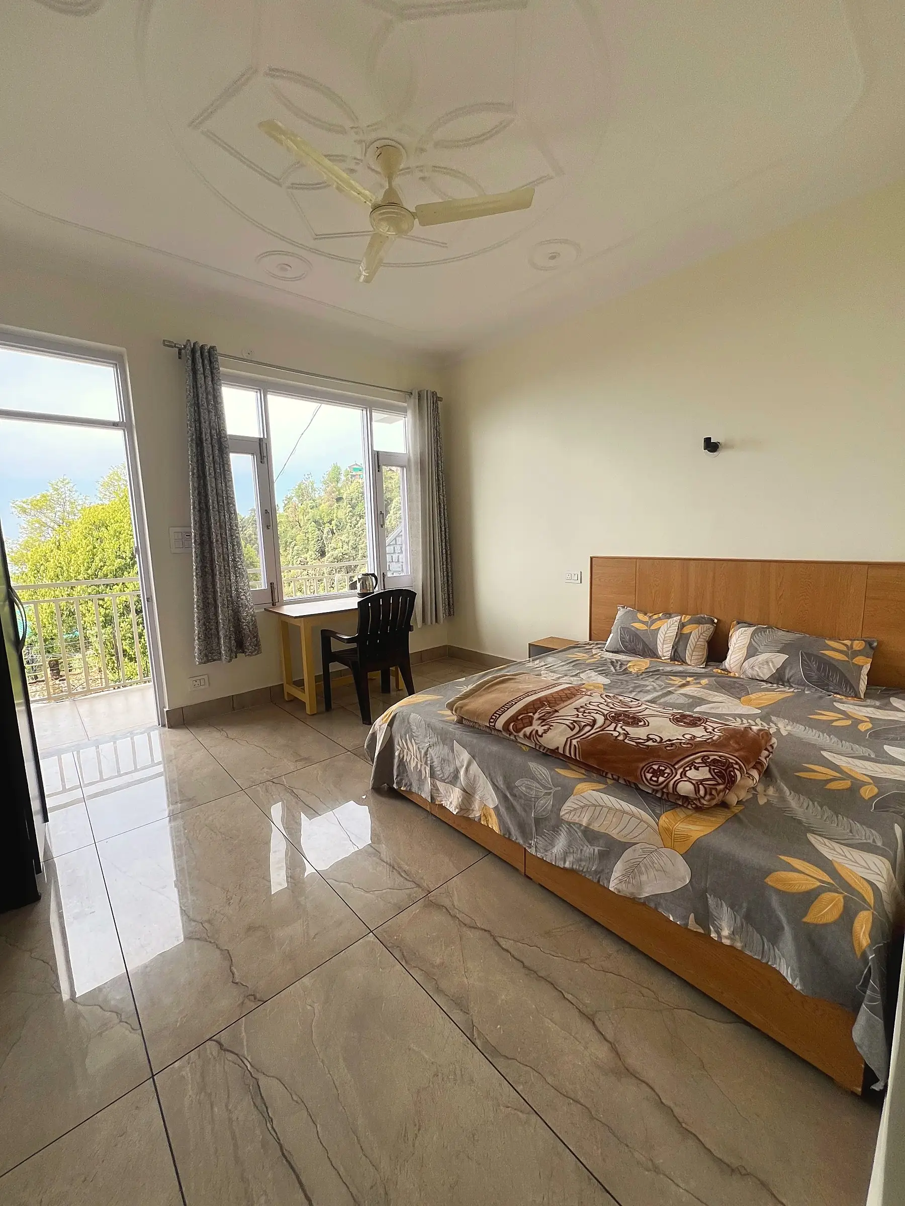 The room, with a double bed and the desk by the window