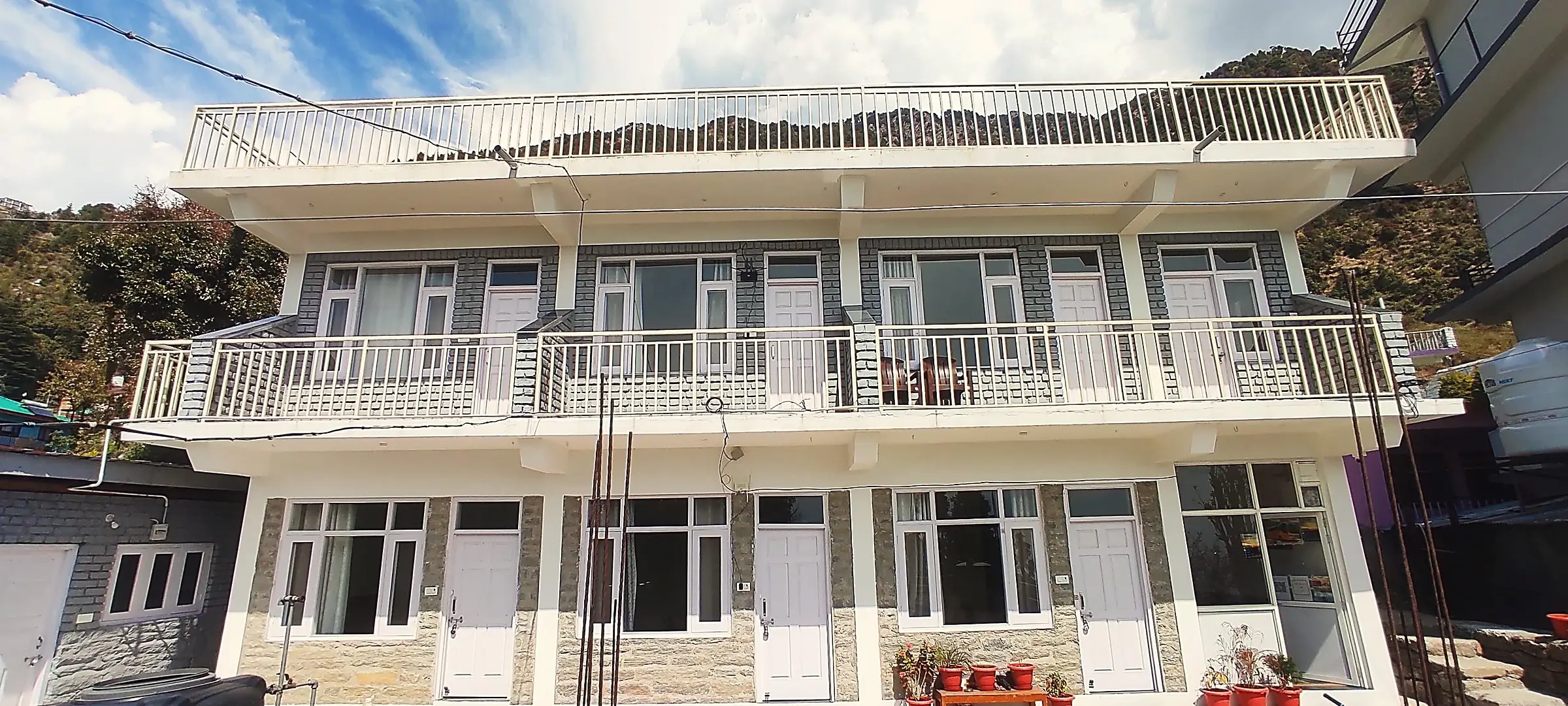 The building from the front, two floors of rooms with balconies