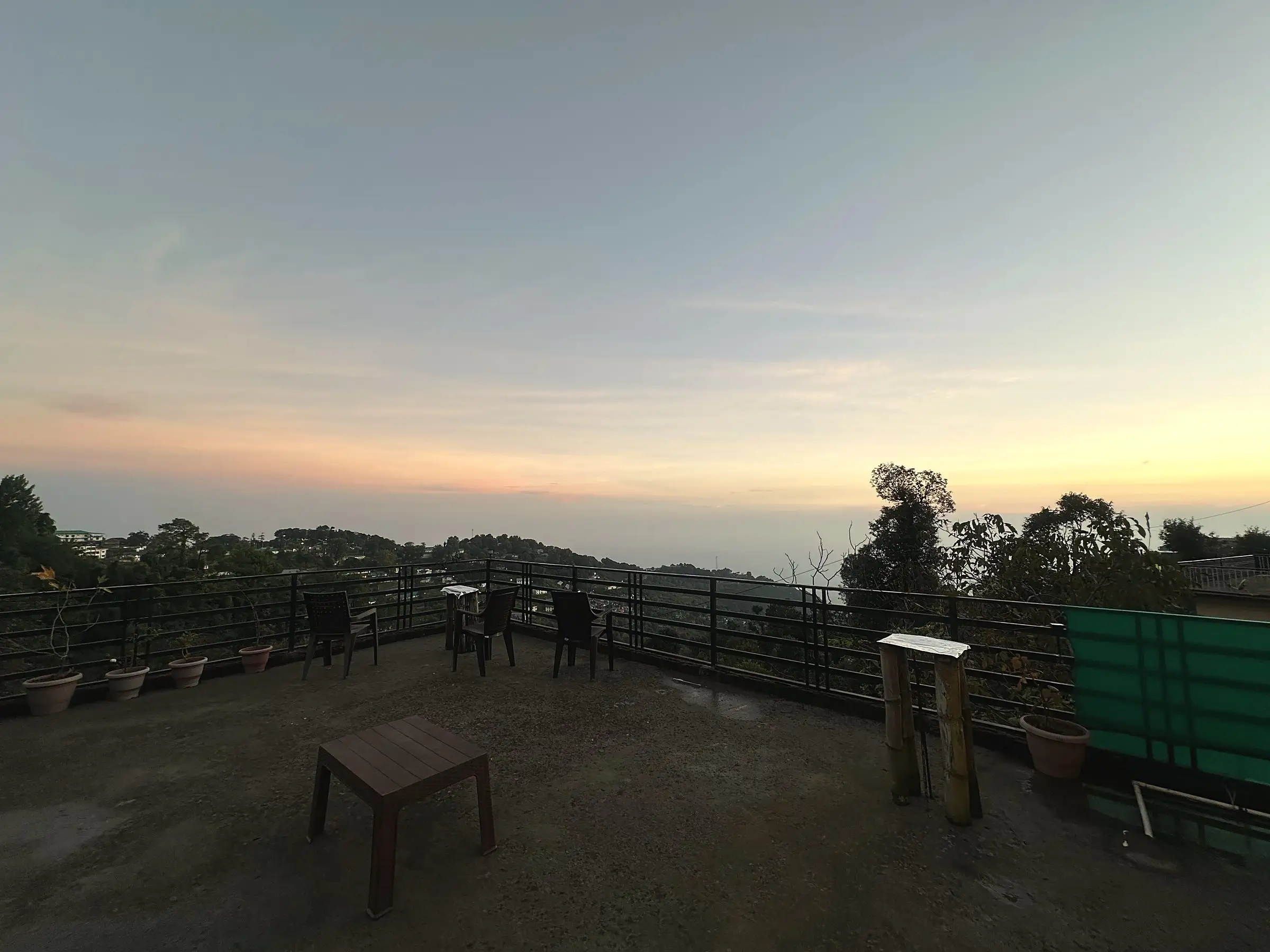 The rooftop terrace at dusk, with chairs facing the horizon