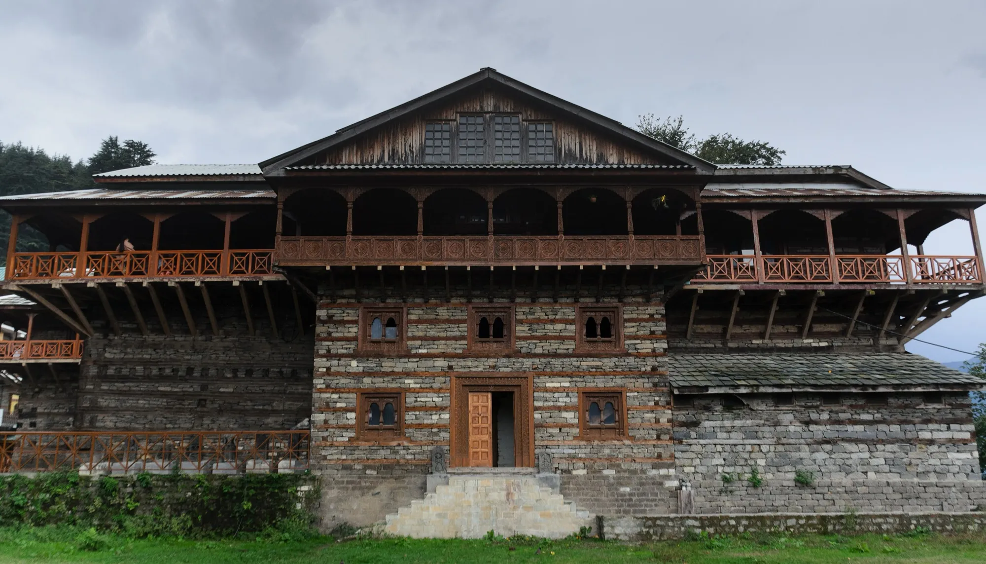 The stone and timber front of Naggar Castle with its carved wooden balconies
