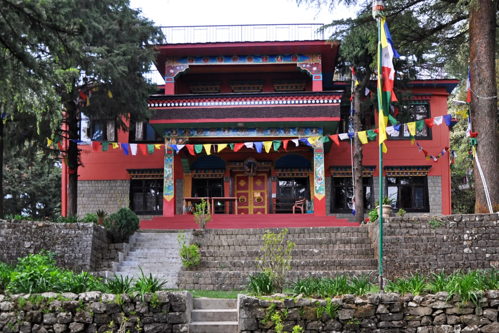The red main gompa at Tushita Meditation Centre in Dharamkot, hung with prayer flags