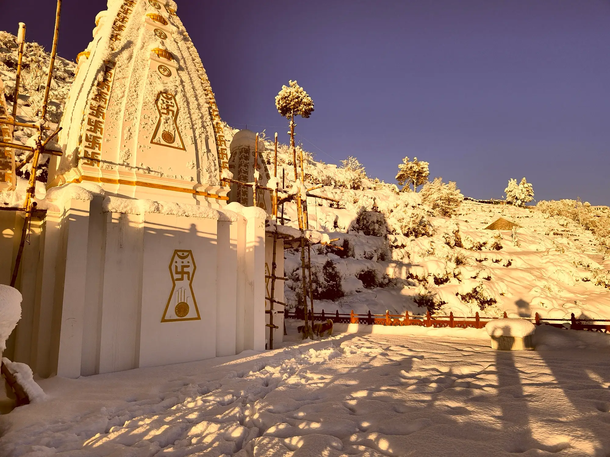 A Jain temple and the hillside around it deep in fresh snow at Mukteshwar